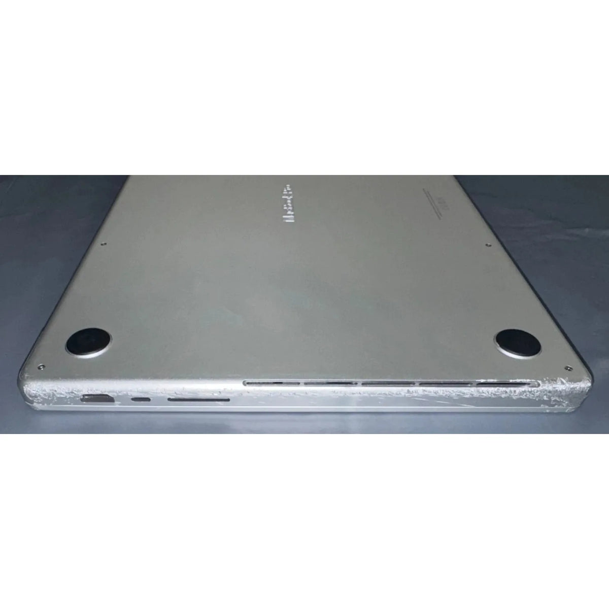 MacBook Pro A2485 actual used unit, heavy casing scratches and dents 